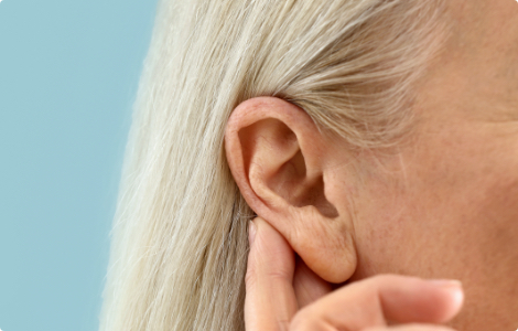 woman holding ear